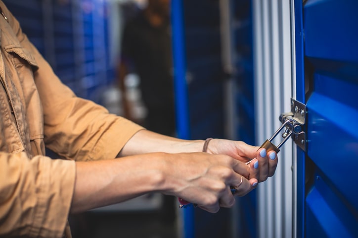 Woman locking storage unit lock.