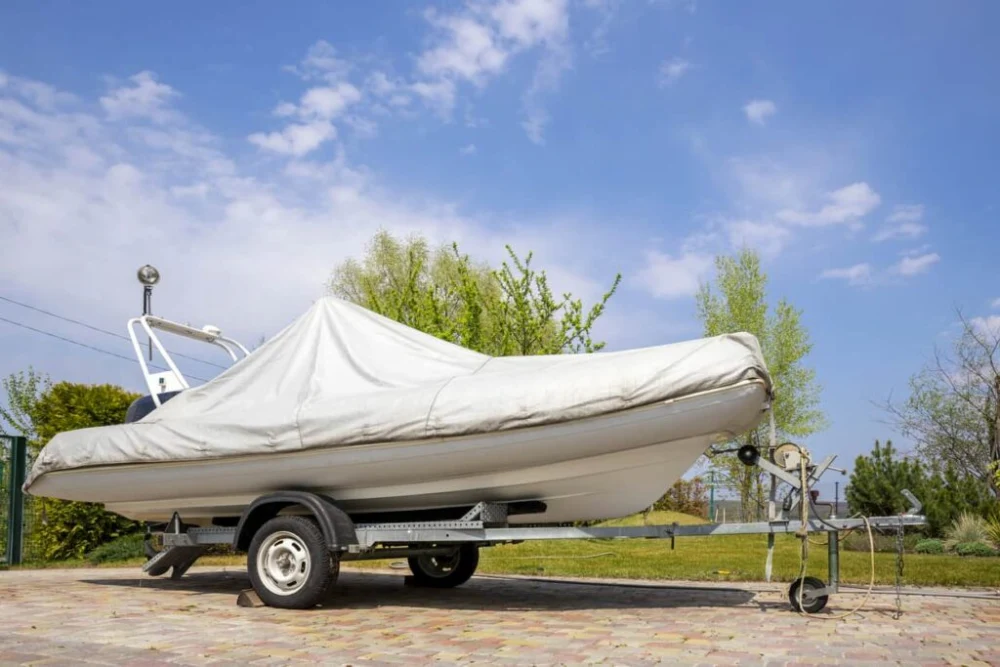 Covered boat parked in a designated storage area.