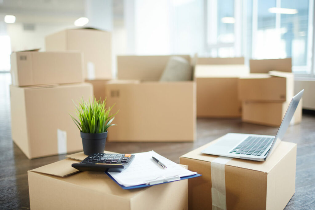 A room full of boxes and a laptop.