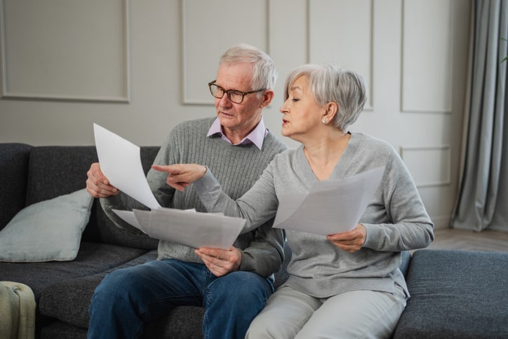 Senior couple organizing important documents for their move. 