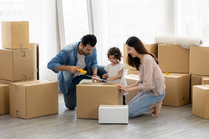 Family packing items in boxes together for their move.